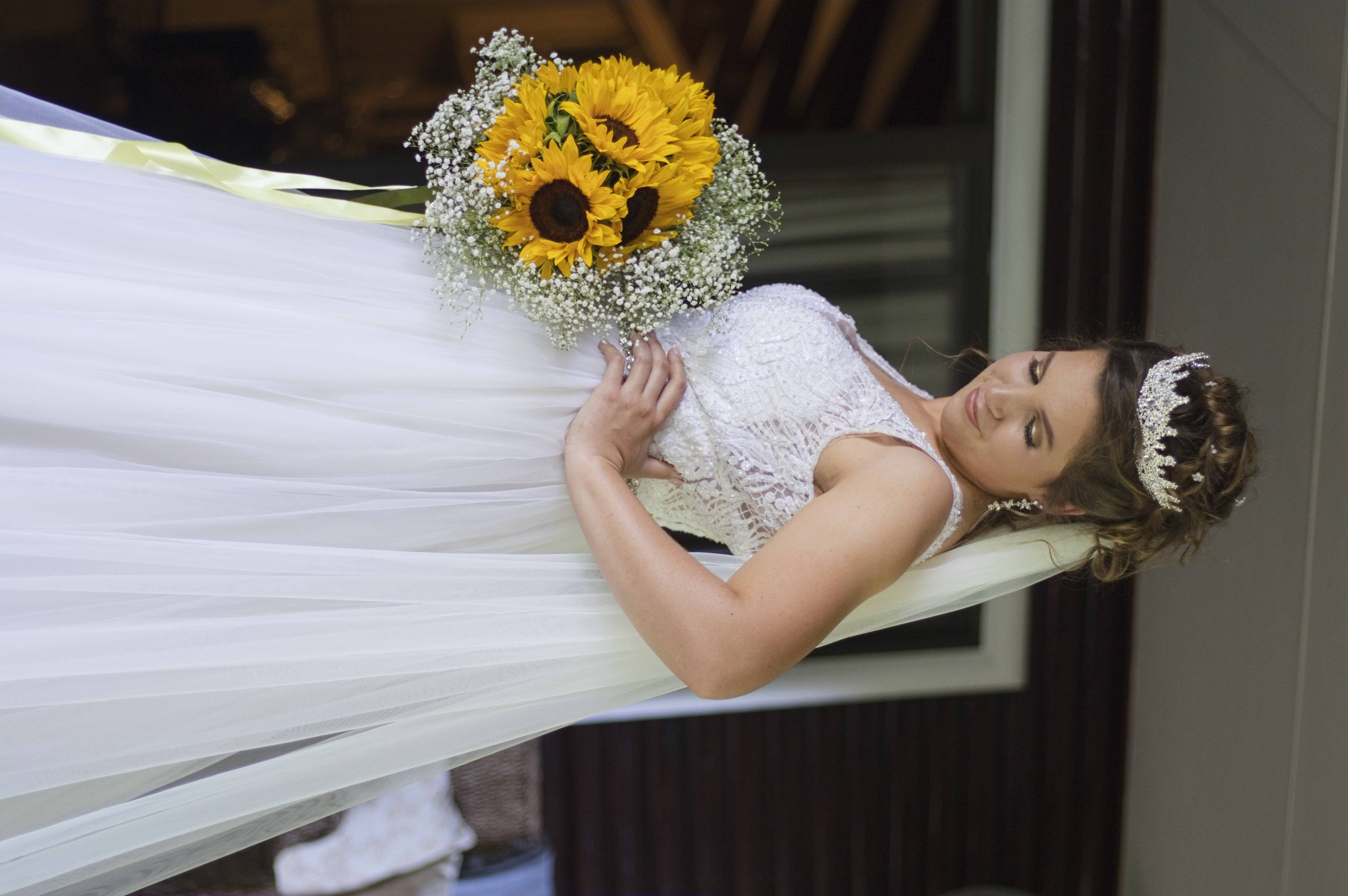 Bride in a crystal tiara holding a sunflower bouquet