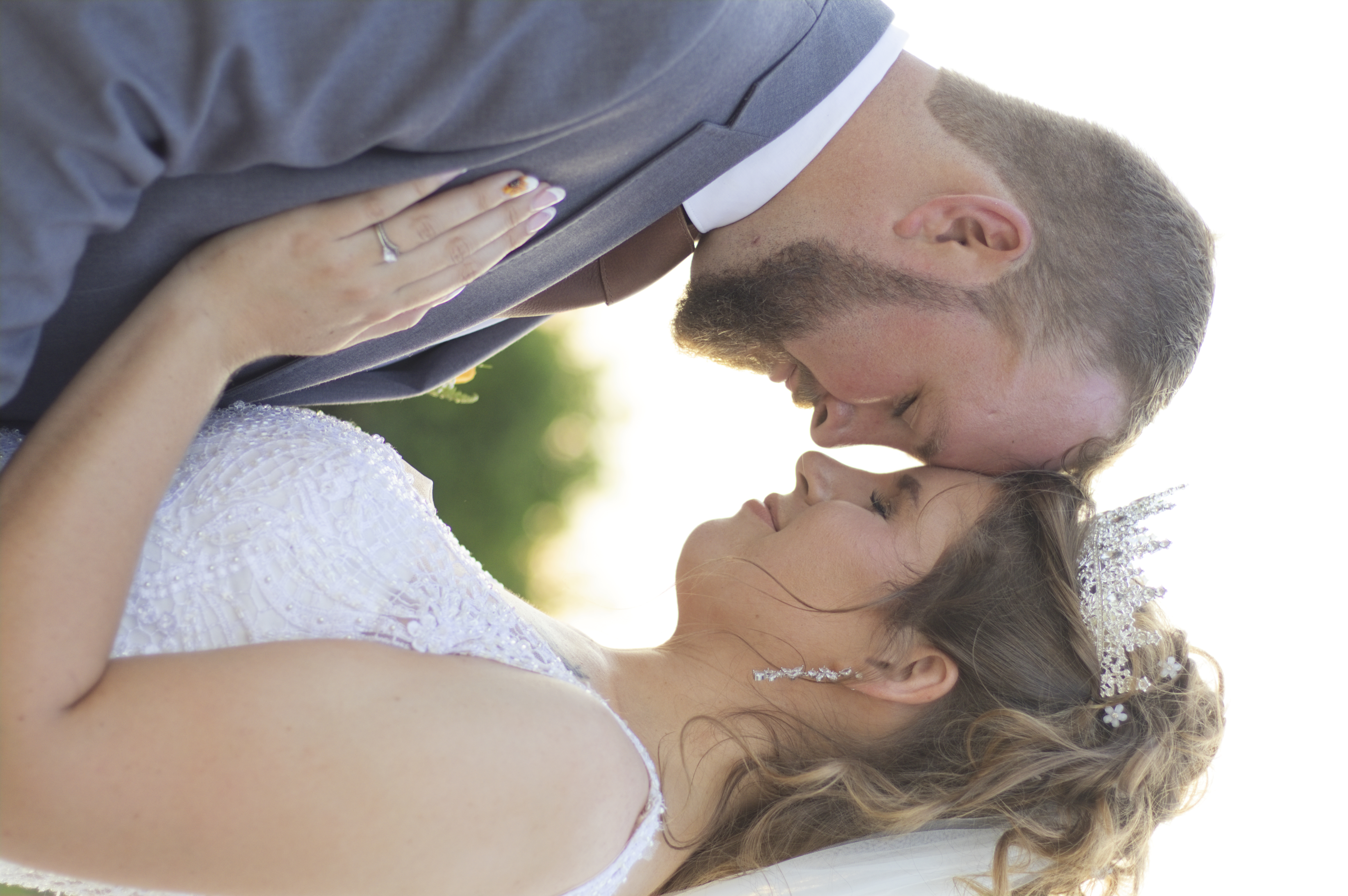 Bride and groom resting foreheads together, eyes closed