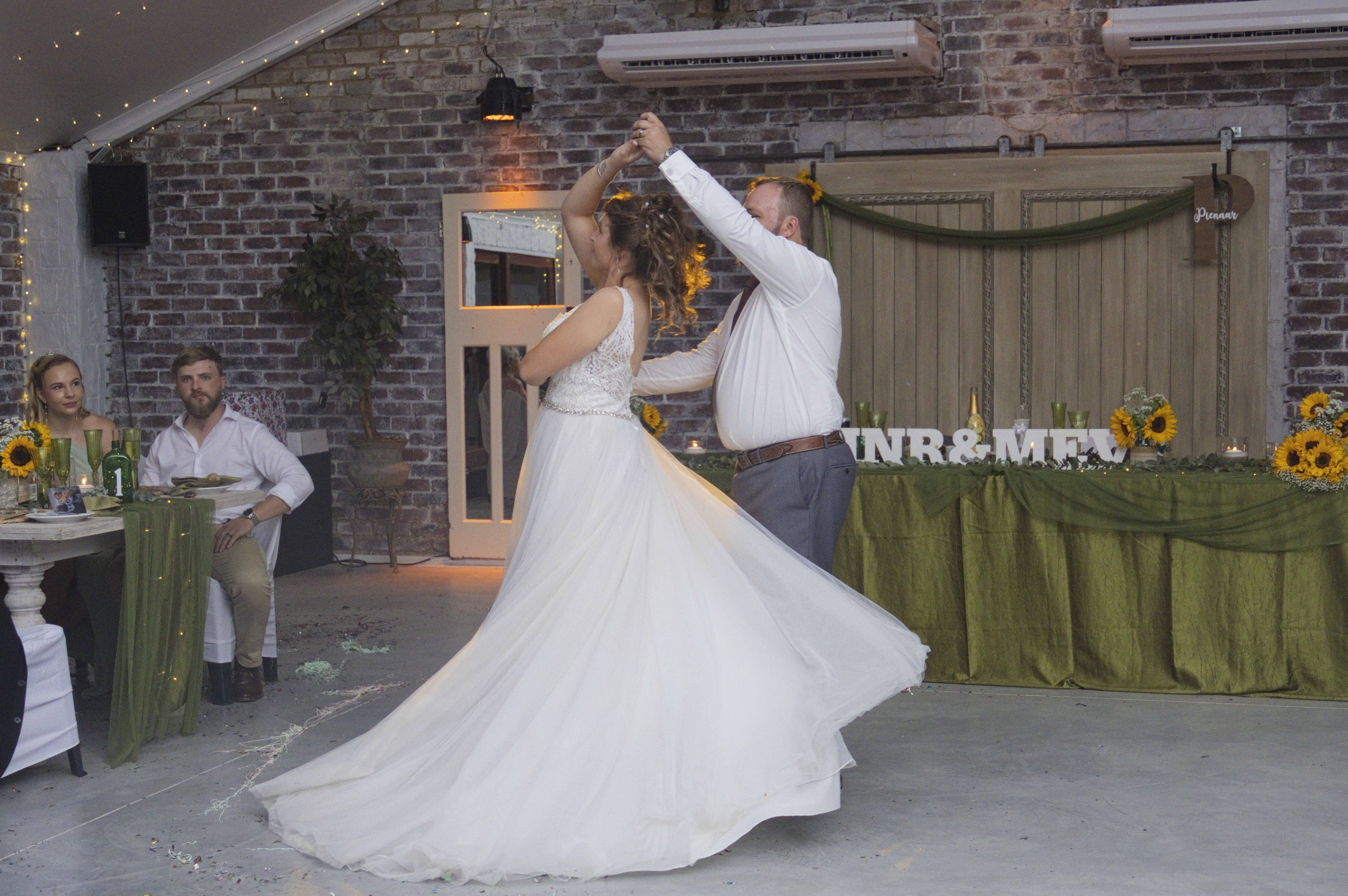 Bride twirling during the first dance at a sunflower reception