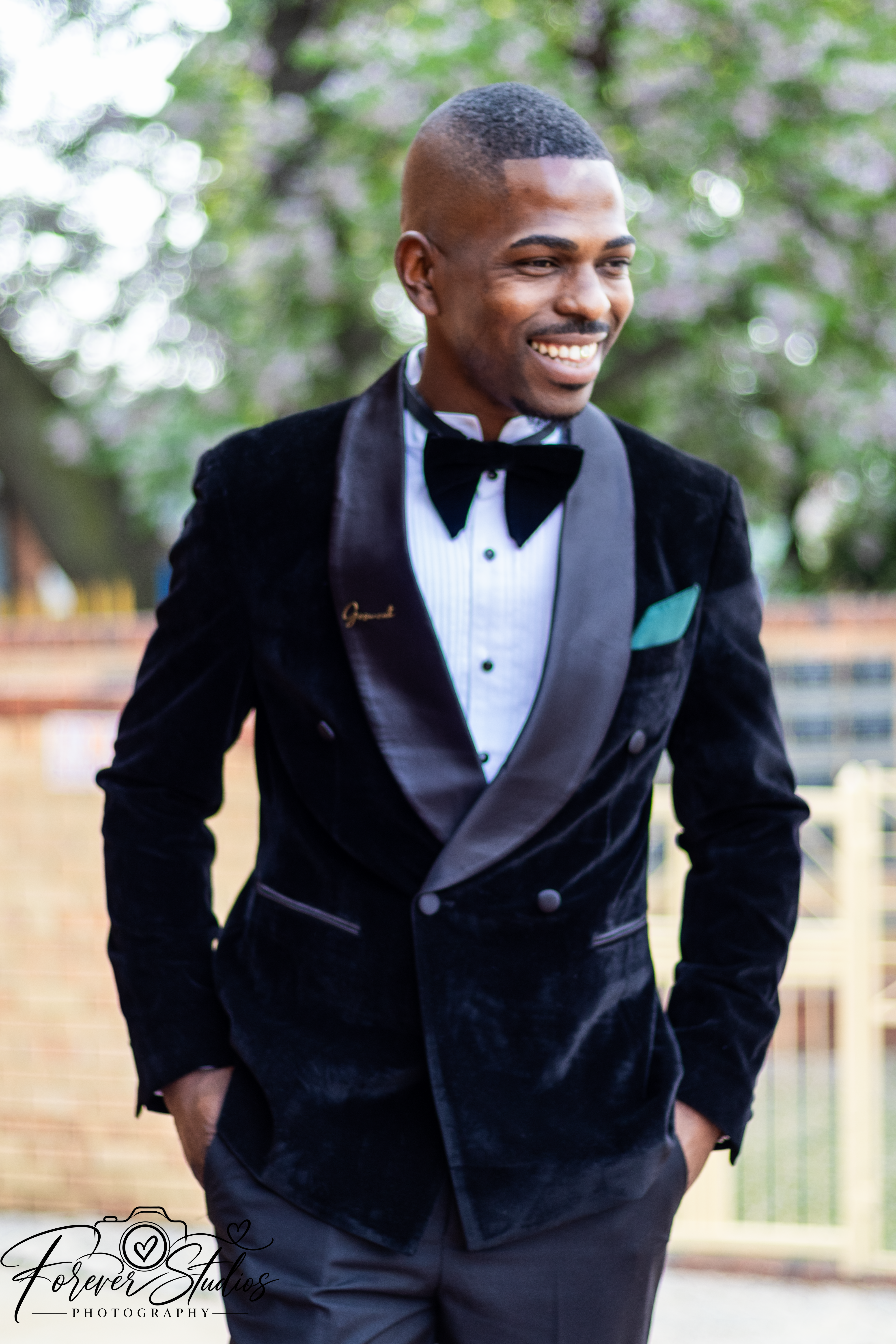 Smiling groom in a black velvet tuxedo